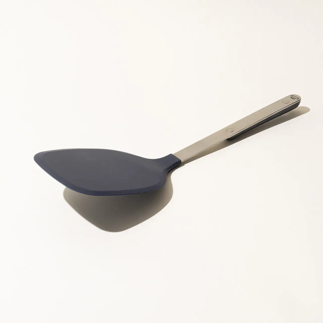 A silicone spatula with a stainless steel handle on a white background.