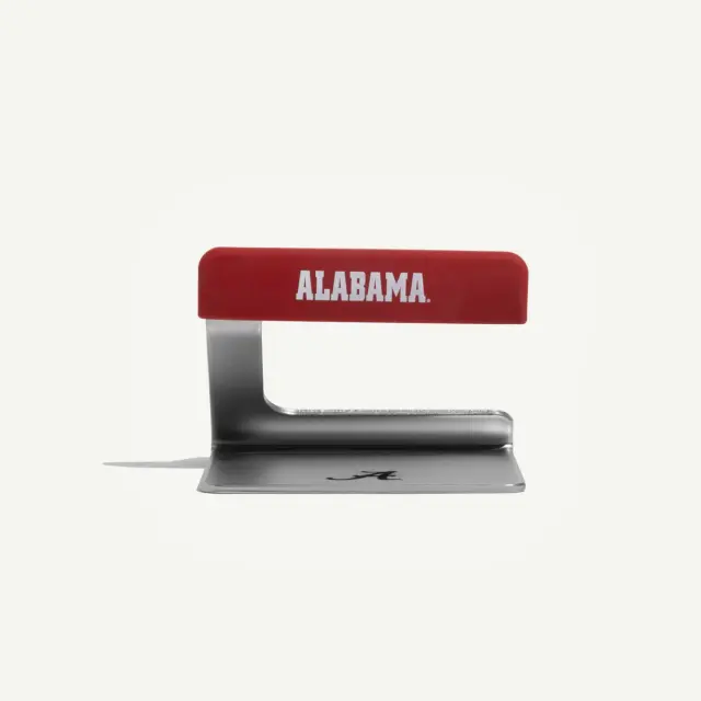 A metal and red plastic kitchen tool with "ALABAMA" printed on the handle.