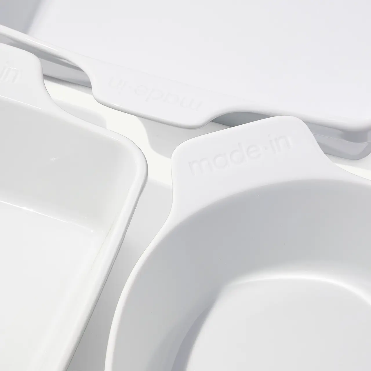 Close-up view of a white compartmentalized tray with "made in" embossed on one section, highlighting the product's origin.