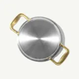 A stainless steel cooking pan with golden handles and the text "MADE IN" engraved on its bottom surface.