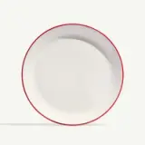 A white plate with a red rim is centered against a light background.