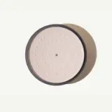 A round, beige speaker with a black rim is pictured against a pale background.