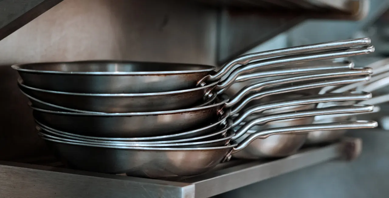 stack of stainless steel frying pans