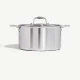 A stainless steel pot with a lid, against a plain background.