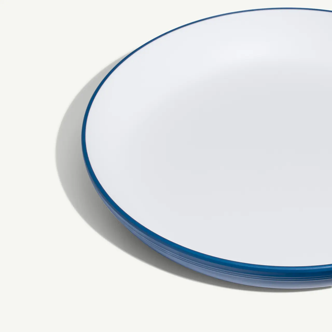 A round, white plate with a blue rim is displayed against a light background.