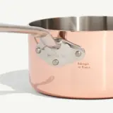 A close-up of a copper saucepan with the brand "made in" and "Fabriqué en France" engraved on its side, set against a light background.