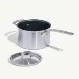 A stainless steel pot with a non-stick coating and its lid placed to the side on a light background.