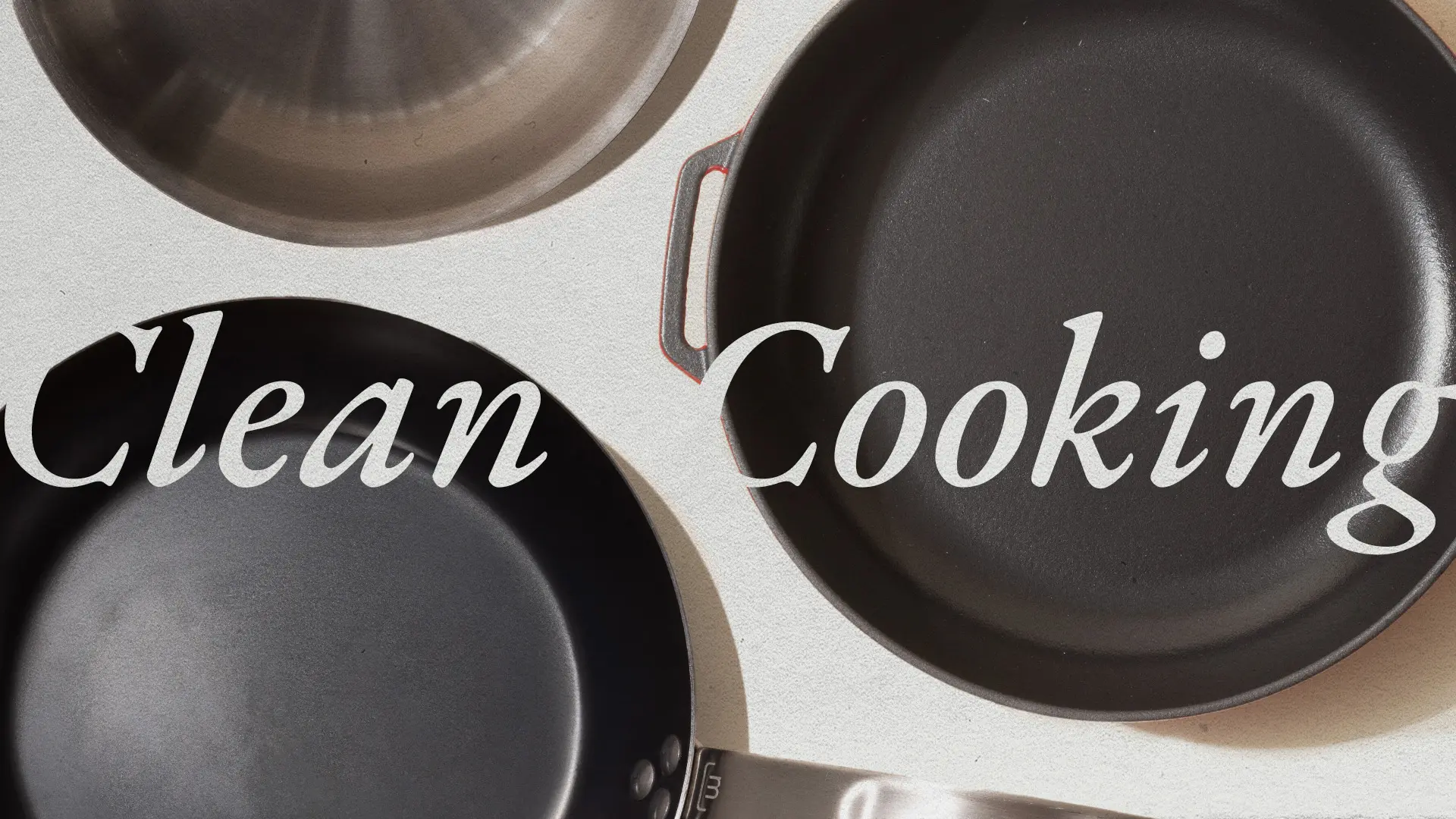 Several clean and unused frying pans are arranged on a surface with the words "Clean Cooking" written across them.