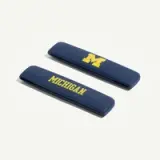 Two dark blue hair barrettes featuring the letters "M" and "MICHIGAN" in yellow lettering.