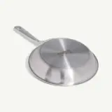 A stainless steel frying pan with a long handle on a light background.