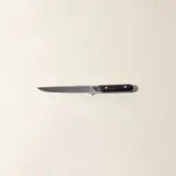 A single kitchen knife with a black handle is centered on a plain light-colored background.