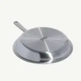 A stainless steel frying pan with a handle, viewed from the top.