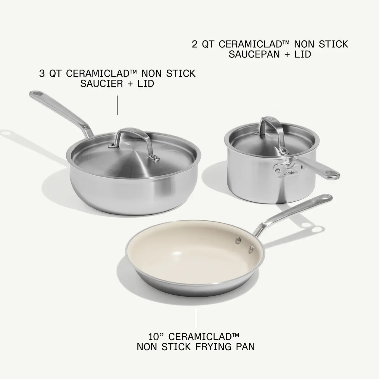 A collection of three non-stick cookware items, including a 2-quart saucepan with lid, a 3-quart saucier with lid, and a 10-inch frying pan, all labeled with their specifications.