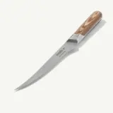 A boning knife with a wooden handle lies on a plain, light background.
