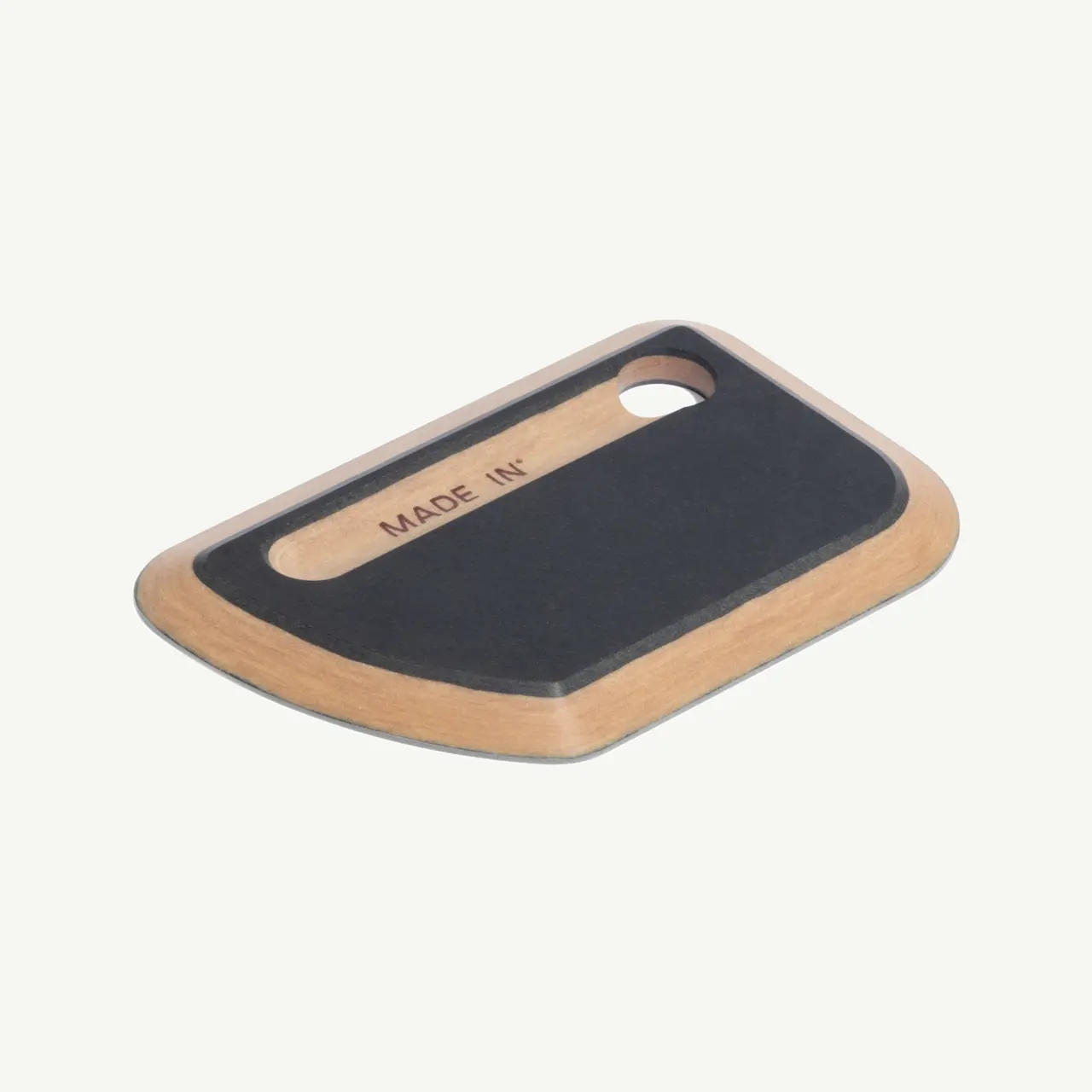 A sleek wooden cutting board with a curved edge and a hole for easy handling.