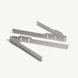 Three architecturally designed, sleek steel bracket pieces are laid out on a white background.