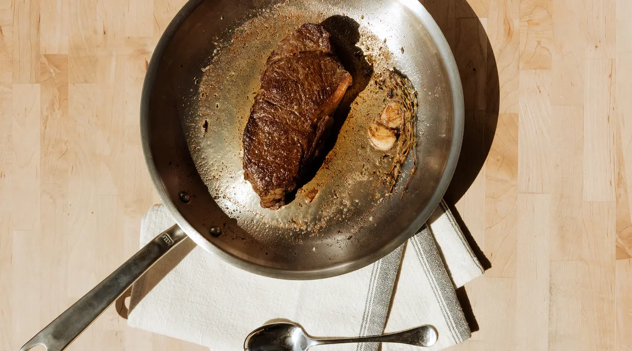 frying pan with steak