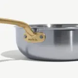 A metallic saucepan with a golden handle features the brand logo "made in" on its side.