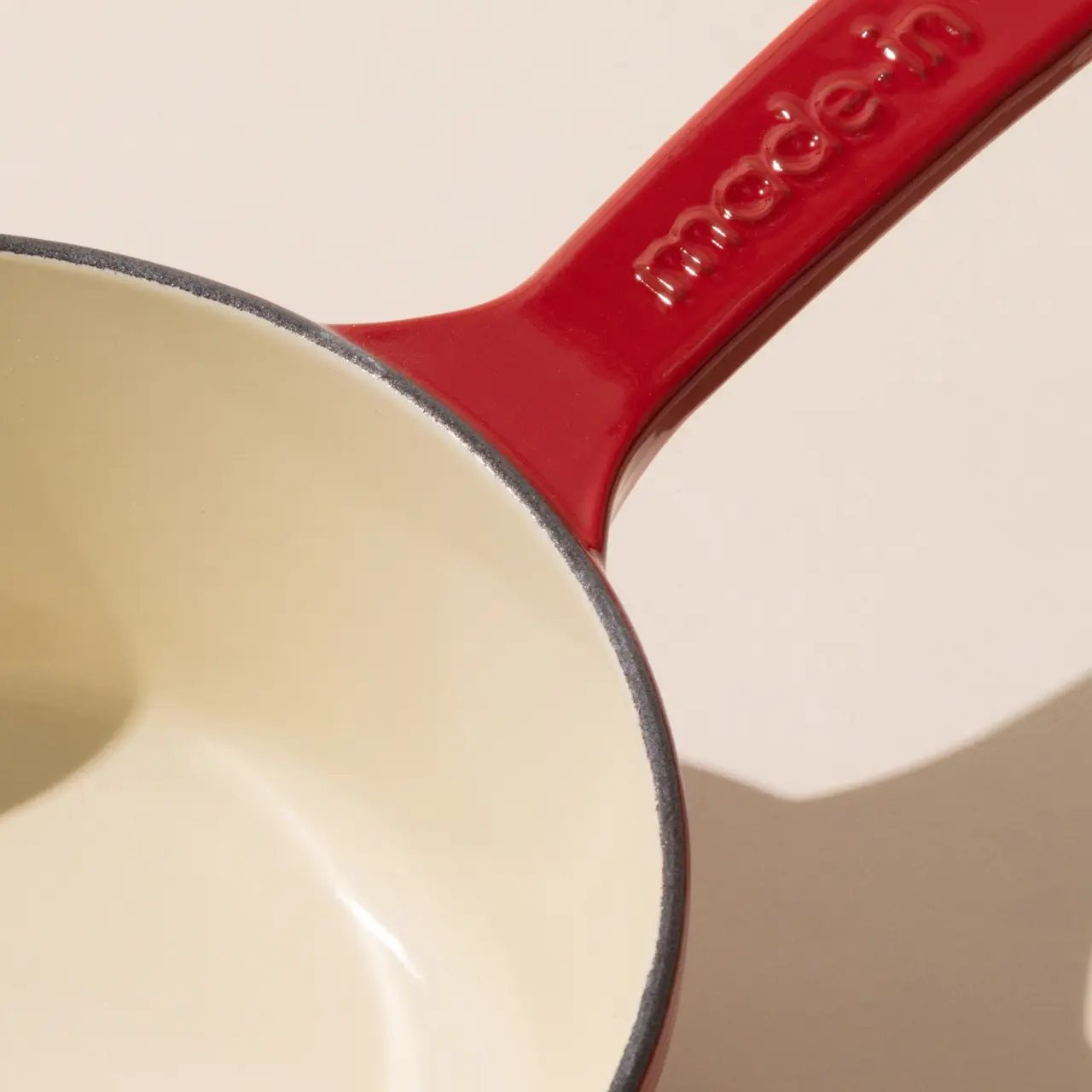 enameled cast iron saucepan made in red surface detail
