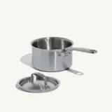 A stainless steel saucepan with a long handle and a matching lid positioned beside it.