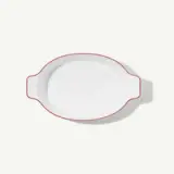 A white oval dish with handles on both sides and a thin red trim around the edge.
