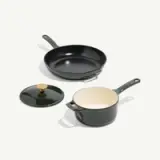 A green cookware set featuring a skillet, a pot with a lid, and a white interior.