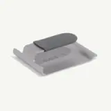 A sleek, gray kitchen tool designed for scraping or flipping food, featuring a curved edge and a smooth handle.