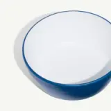 A round bowl with a white interior and a blue rim.