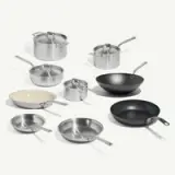 A collection of various pots and pans in different sizes and materials arranged aesthetically.