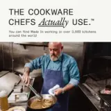 A bearded chef expertly cooks in a busy kitchen, showcasing high-quality cookware.