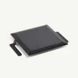 A black geometric-shaped griddle with handles on either side lies against a white background.