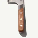 A sharp kitchen knife with a decorative blade and a wooden handle featuring three rivets.