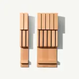 Two different-sized wall-mounted wooden knife racks are displayed side by side.