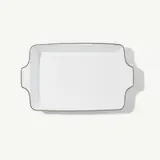A white rectangular baking dish with handles on both sides is shown on a light background.