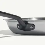 A close-up of a stainless steel saucepan highlights the riveted handle with the text "made in" on a white background.