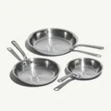 Three stainless steel frying pans of varying sizes are arranged on a white background.