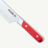 A knife with a red handle and the brand name "made.in" on the blade.
