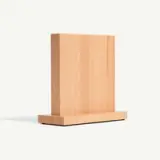 A wooden knife storage block stands upright on a flat surface.