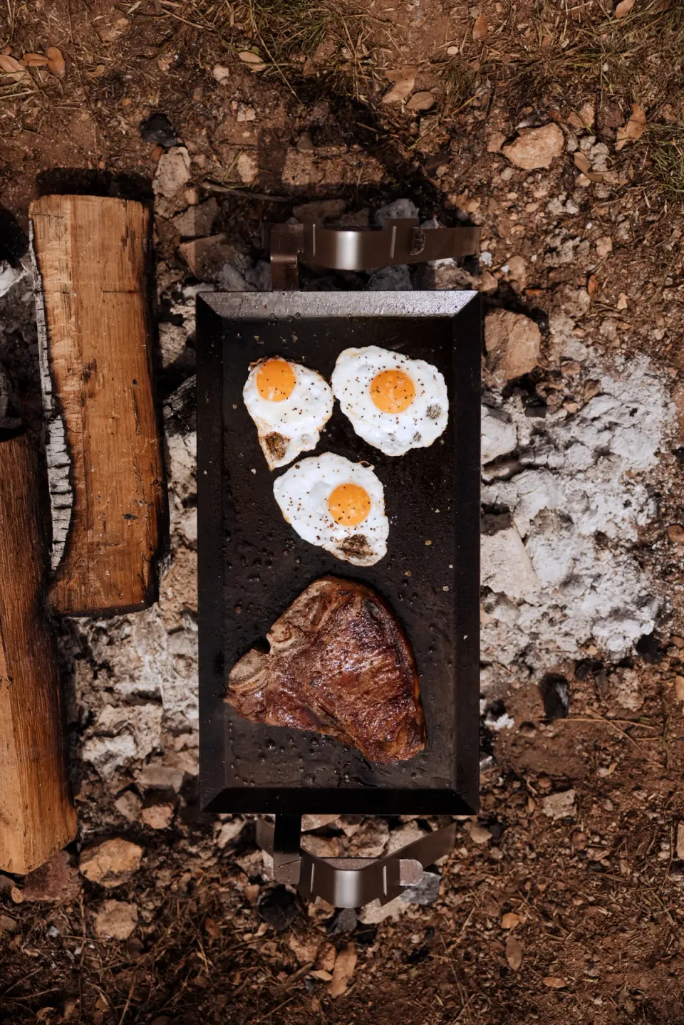 steak and eggs on griddle
