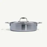 A stainless steel, lidded, oval-shaped cooking pot is shown against a plain background.