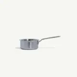 A stainless steel saucepan with a long handle is displayed against a plain light background.