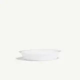 A plain, white ceramic dish is displayed against a light background.