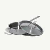 A stainless steel pan with a long handle and a matching lid.