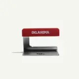 A red and silver kitchen utensil with the word "OKLAHOMA" printed on the handle.