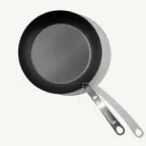 A non-stick frying pan with a metal handle is shown against a white background.