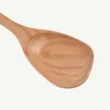 A wooden spoon with a broad, rounded bowl and smooth finish.