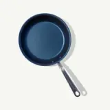 A non-stick frying pan with a metal handle is shown against a plain background.