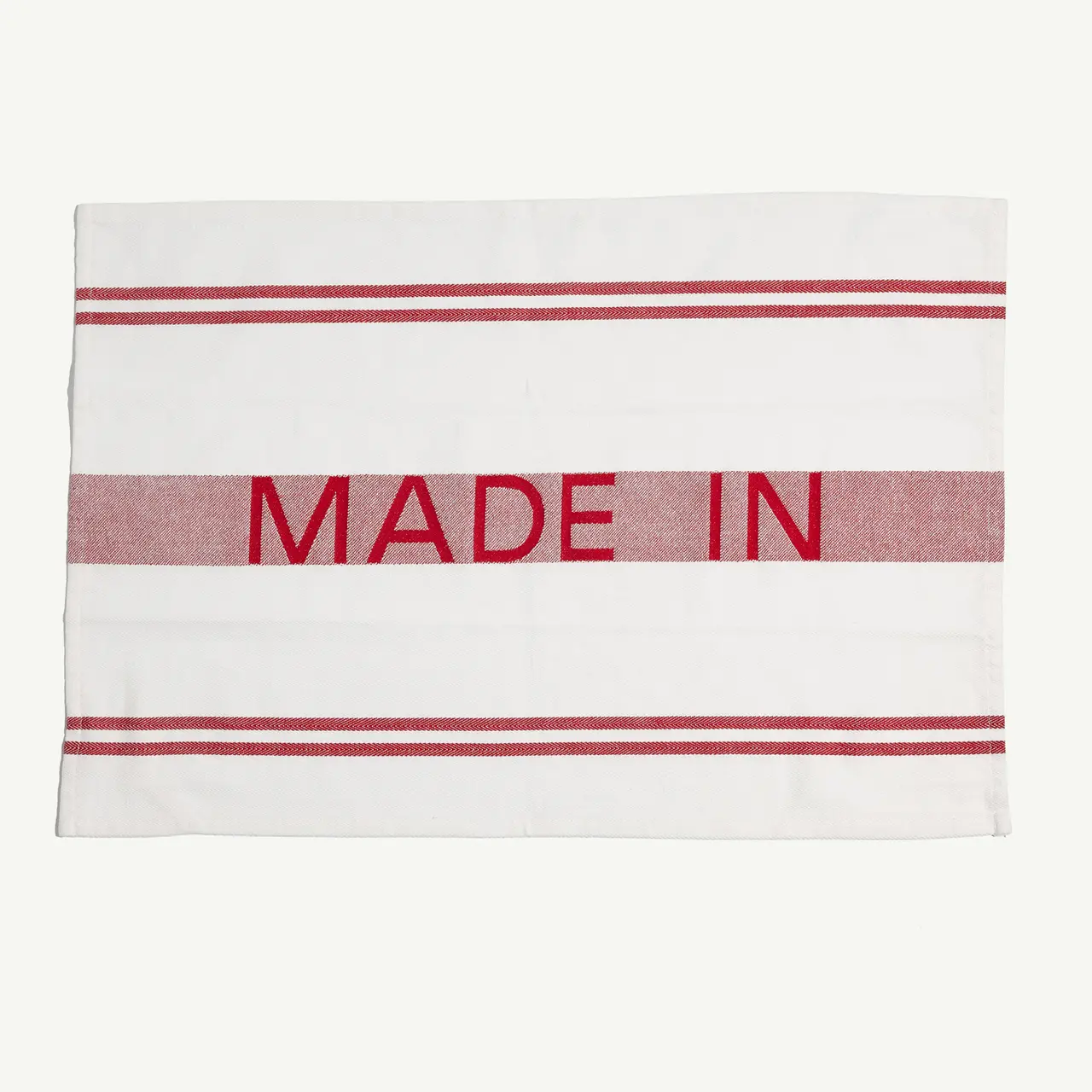 A white label is shown with red stripes and the words "MADE IN" printed in red letters, leaving the origin unspecified.