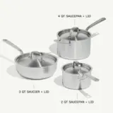 Three stainless steel cooking pots of varying sizes, including a 2-quart saucepan, a 3-quart saucier with a lid, and a 4-quart saucier with a lid, are displayed together.
