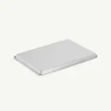 A rectangular metal baking sheet with slightly raised edges lies on a plain white background.